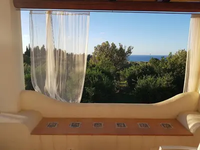 a large window with a view of the ocean at Terre e Torri Country Resort in Lascari
