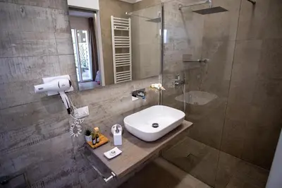 a bathroom with a sink and a shower at Le Muse Mondello in Mondello