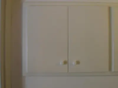 a white cabinet with two doors on a wall at Olivella Suite Ecological House in Palermo