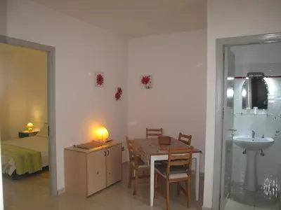 a room with a table and a sink and a bedroom at Casa Il Papiro TRS-IT-SIC-20280 in Palermo