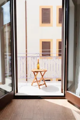 an open door to a balcony with a table at Il Glicine Appartamenti & Rooms in Castellammare del Golfo