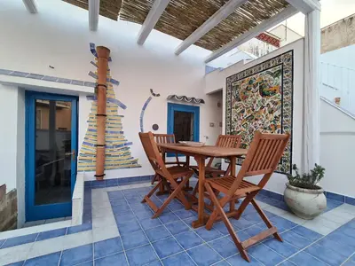 a wooden table and chairs on a patio at casa sul mare in Terrasini