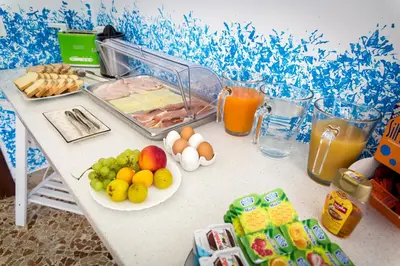 a table with fruits and vegetables and drinks on it at Colors B&B in Palermo