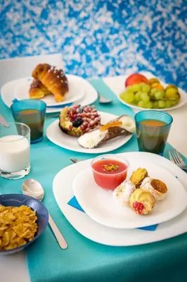 a table with plates of food on a table at Colors B&B in Palermo