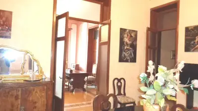 a room with an open door with a chair and a mirror at Casa nobiliare in Palermo