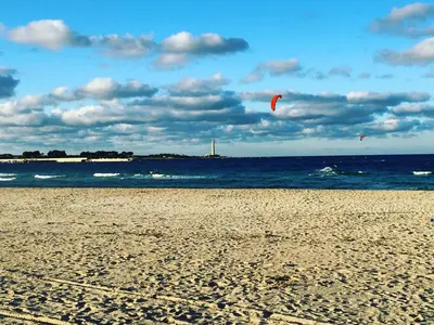 two kites flying over the ocean on a beach at I Segreti di Antonina in Castelluzzo