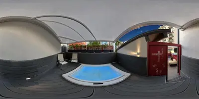 a large swimming pool in a building with an aquarium at Hospitality Hotel in Palermo