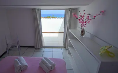 a room with a table and a vase with towels at Villa Trinacria Apartments in Alcamo Marina