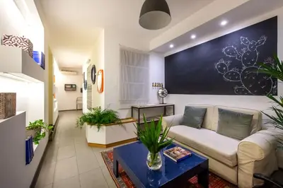 a living room with a couch and a table at Pretoria Rooms in Palermo
