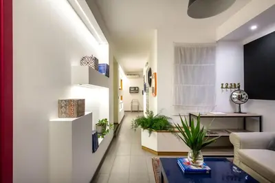 a living room with a couch and a table at Pretoria Rooms in Palermo