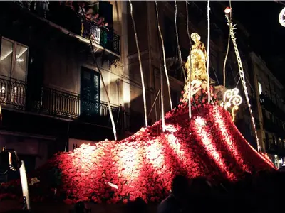 a large pile of red flowers in front of a building at Casakameusa in Palermo