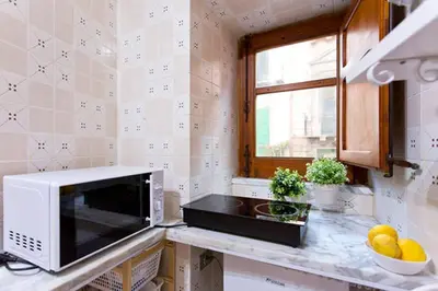a kitchen with a microwave on a counter at Casakameusa in Palermo