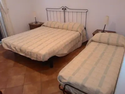 a bedroom with two beds and two night stands at Il Noce Antico in Bisacquino