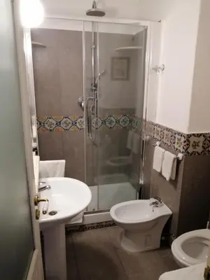 a bathroom with a shower and a sink and a toilet at Palazzo Benso in Palermo