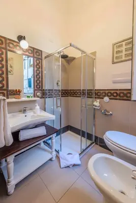 a bathroom with a shower and a sink and a toilet at Palazzo Benso in Palermo