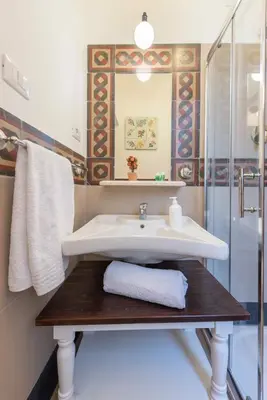 a bathroom with a sink and a shower at Palazzo Benso in Palermo