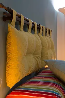 a bunch of pillows hanging on a bed at Le Case Moncada in Palermo
