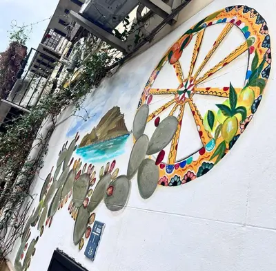 a painting of a ferris wheel on the side of a building at Bahalara Alloggio in Palermo