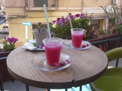 two glasses of pink drinks sitting on a table at Bahalara Alloggio in Palermo