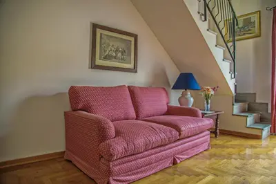 a living room with a couch and a staircase at Palazzo Trinacria in Palermo