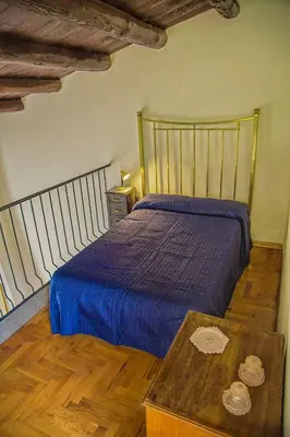 a bedroom with a bed and a wooden table at Palazzo Trinacria in Palermo