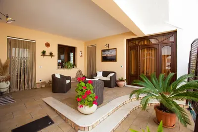 a living room with couches and flowers in at Alba Marina B&B in Castelluzzo
