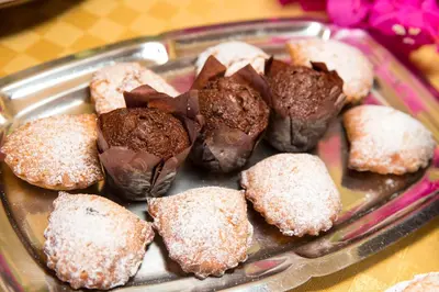 a tray of chocolate covered donuts on a table at Alba Marina B&B in Castelluzzo