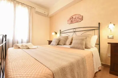 a bedroom with a large bed in a room at Bed & Breakfast Goccia Marina in San Vito lo Capo