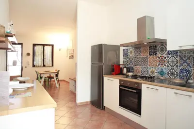 a kitchen with a refrigerator and a stove top oven at Acquamarina32 in San Vito lo Capo