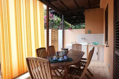 a wooden table and chairs in a kitchen at Acquamarina32 in San Vito lo Capo