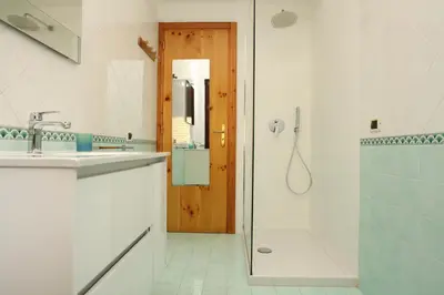 a bathroom with a shower and a sink and a mirror at Acquamarina32 in San Vito lo Capo