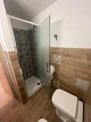 a bathroom with a toilet and a shower at Hotel Cortese in Palermo