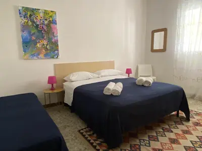 a bedroom with a bed with two towels on it at Maresole apartments - direttamente sul mare in Alcamo Marina