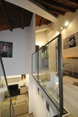 a living room with a glass staircase in a house at Papireto 11 Loft in Palermo