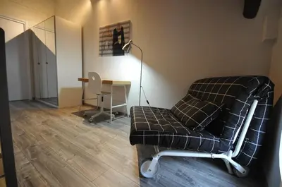 a living room with a chair and a desk at Papireto 11 Loft in Palermo