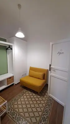 a living room with a yellow couch and a tv at Fiori d'Arancio in Terrasini