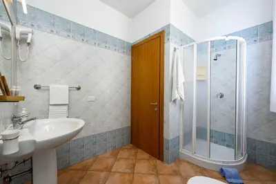 a bathroom with a sink toilet and a shower at Sun Garden in San Vito lo Capo