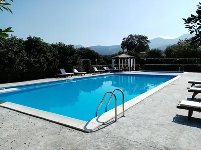 a swimming pool with blue water in a resort at Ville dell'Eden con 9 camere da letto in 6 unità abitative in Lascari
