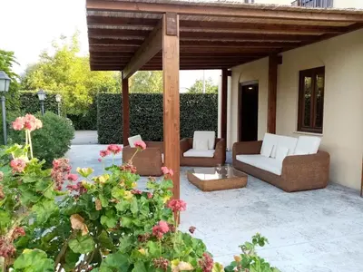 a patio with two couches and a pergola at Ville dell'Eden con 9 camere da letto in 6 unità abitative in Lascari