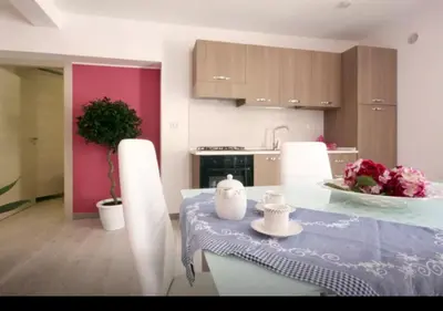 a kitchen with a table with a table cloth on it at Rainbow in Castellammare del Golfo