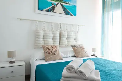 a bedroom with a bed with towels on it at Mondello House Eraclea in Mondello