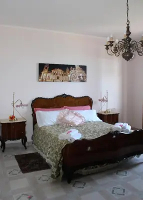 a bedroom with a bed and two night stands at Palazzo Scavone in Palermo