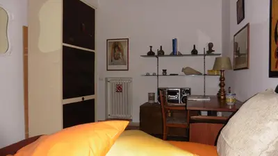 a living room with a desk and a couch at Bobnb in Palermo