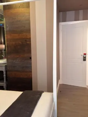a bedroom with a white door and a bed at 29 Venti Luxury in Palermo