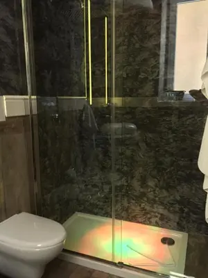 a bathroom with a toilet and a shower with a glass door at 29 Venti Luxury in Palermo