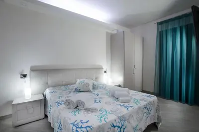 a bedroom with a bed with towels on it at Monte Monaco B&B in San Vito lo Capo