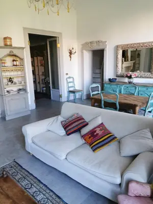 a living room with a white couch with pillows on it at Piazza Marina Chic in Palermo