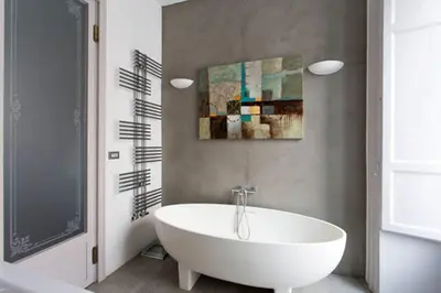 a white bath tub in a bathroom with a painting at Piazza Marina Chic in Palermo