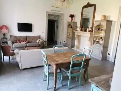 a living room with a table and chairs and a couch at Piazza Marina Chic in Palermo