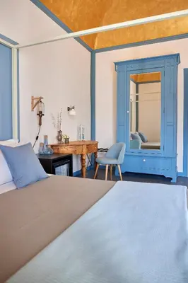a bedroom with a bed and a desk at Curù in Castellammare del Golfo
